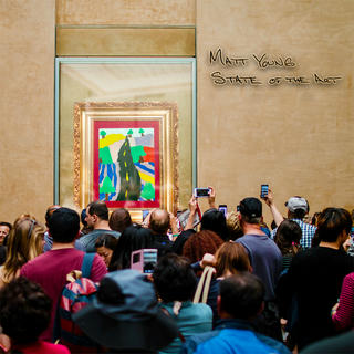 A photograph of a group of people in an art museum crowded around a child's drawing which is behind glass